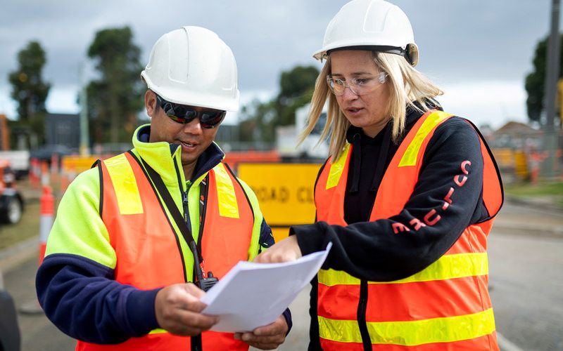 Male and female employee going over the schedule