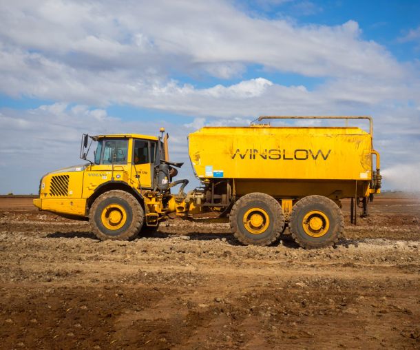 Water truck sprying water on soil